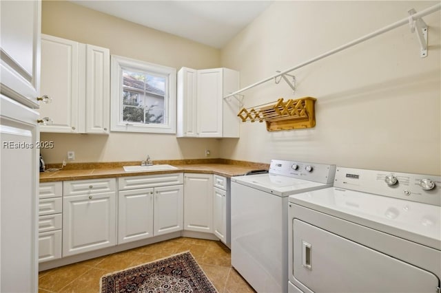 laundry area featuring sink, cabinets, washer and dryer, and light tile patterned flooring