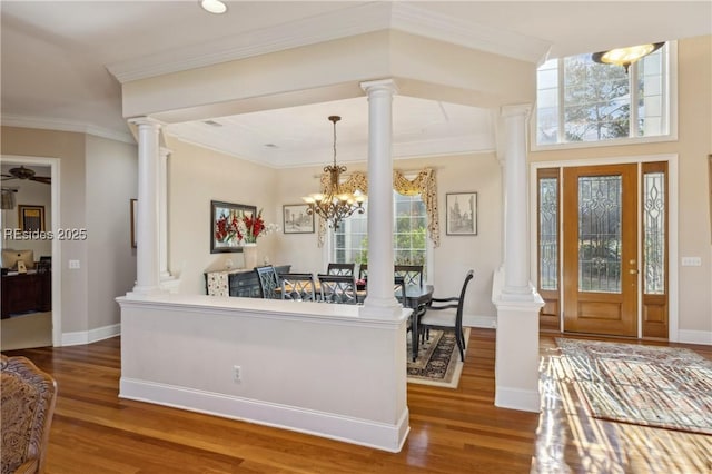 interior space featuring ornamental molding, decorative columns, and a healthy amount of sunlight