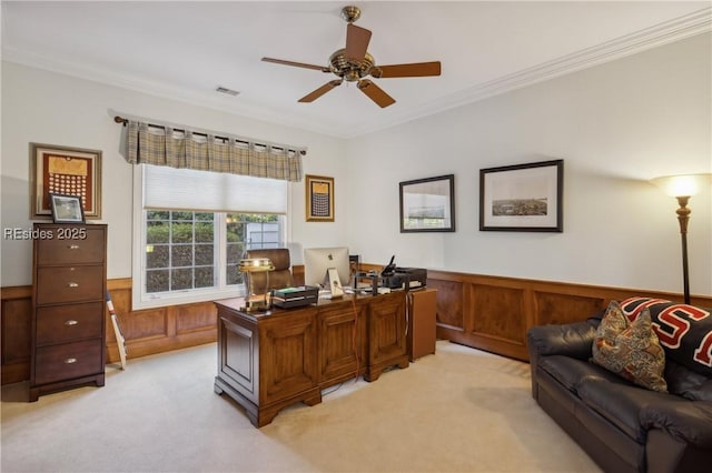 carpeted office featuring wooden walls, ornamental molding, and ceiling fan