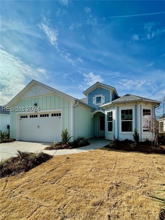 view of front of property with a garage and a front yard