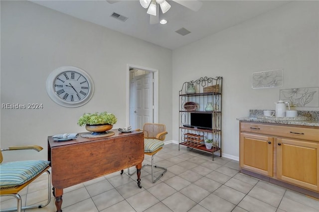 office area with ceiling fan and light tile patterned floors