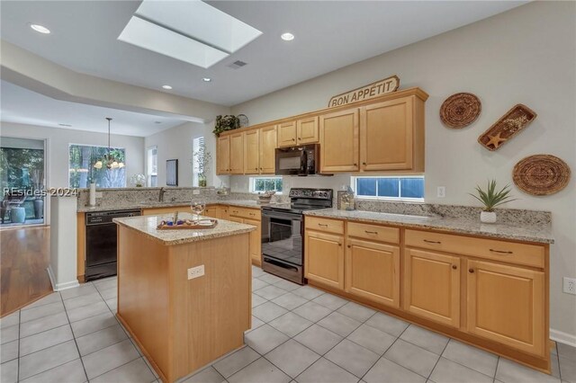 kitchen featuring black appliances, a center island, pendant lighting, and kitchen peninsula