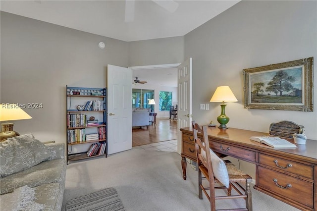 office featuring ceiling fan and light carpet