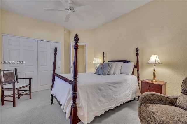 bedroom with ceiling fan, light colored carpet, and a closet