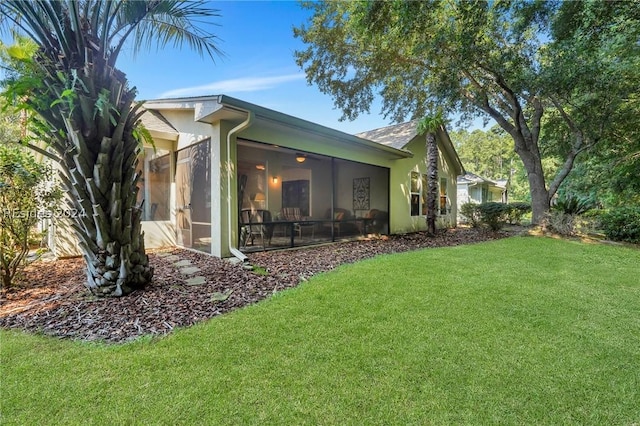 exterior space featuring a yard and a sunroom