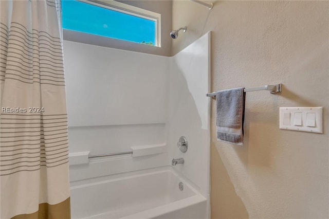 bathroom featuring shower / bathtub combination with curtain