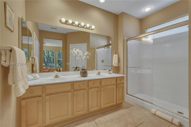 bathroom featuring tile patterned flooring, an enclosed shower, and vanity