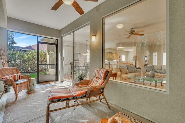 sunroom / solarium featuring ceiling fan and a healthy amount of sunlight