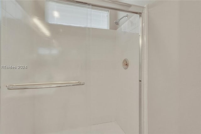 bathroom featuring a shower with door