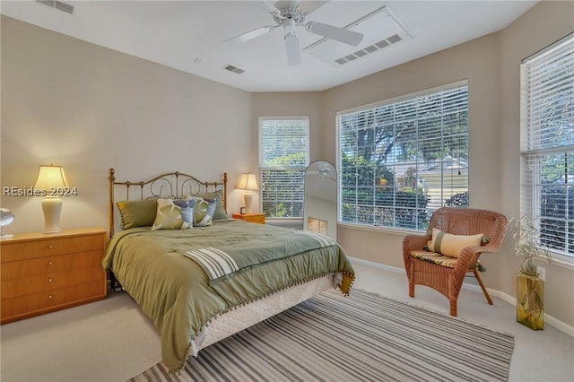 bedroom featuring ceiling fan, carpet floors, and multiple windows