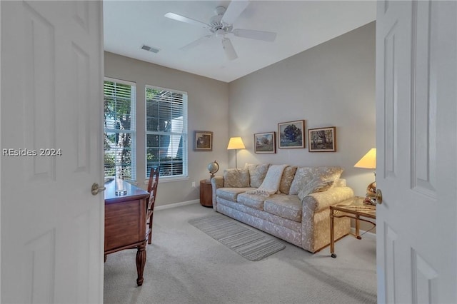 living room with light colored carpet and ceiling fan