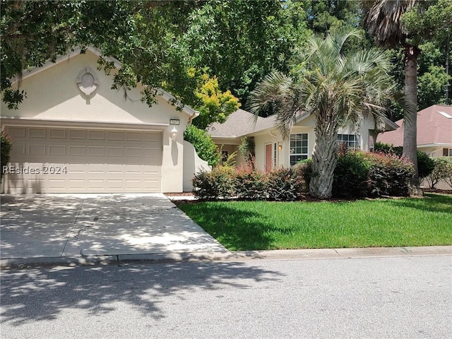 view of front of home with a garage and a front yard