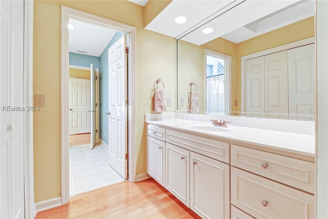 bathroom with vanity and hardwood / wood-style floors