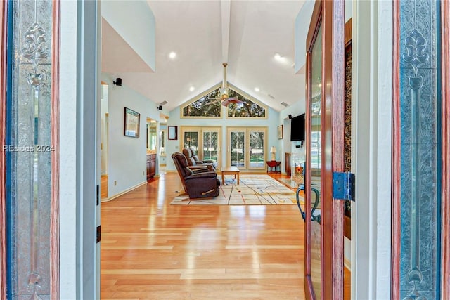 entryway with wood-type flooring, french doors, and vaulted ceiling