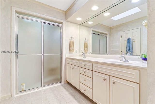 bathroom with vanity, tile patterned floors, a skylight, and a shower with door