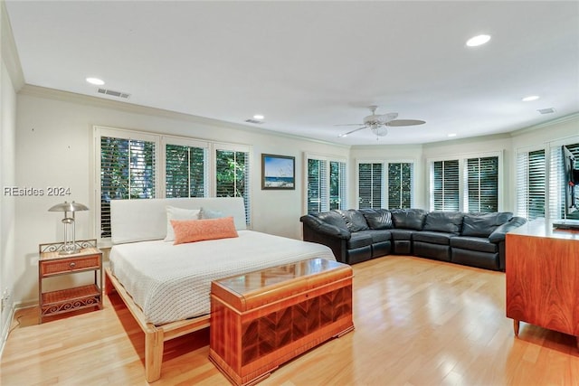 bedroom with light hardwood / wood-style flooring, ornamental molding, and ceiling fan