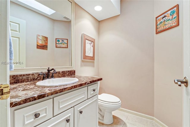 bathroom with vanity, toilet, and tile patterned flooring