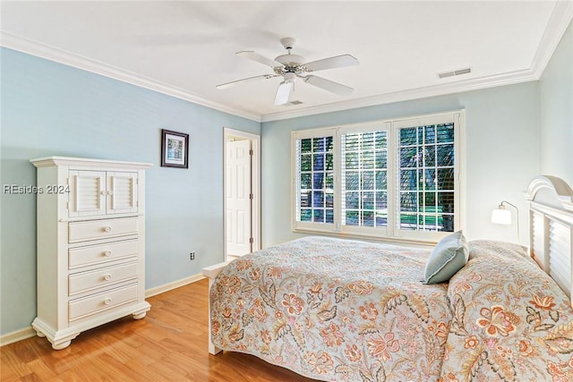 bedroom featuring ornamental molding, ceiling fan, and light wood-type flooring