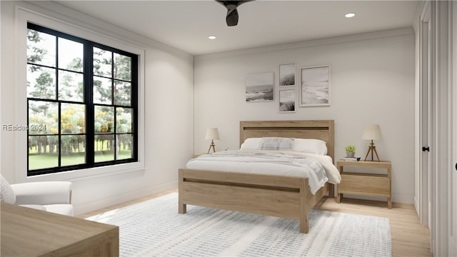 bedroom featuring ornamental molding, light hardwood / wood-style floors, and ceiling fan