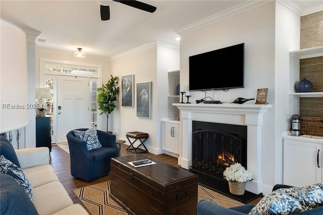 living room featuring crown molding, ceiling fan, and wood-type flooring