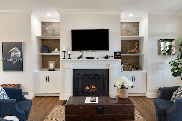 living room featuring crown molding, wood-type flooring, and built in features