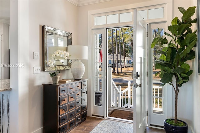 entryway with crown molding and dark hardwood / wood-style floors