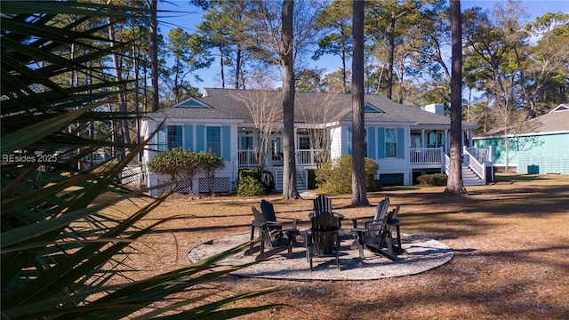 back of property with a fire pit