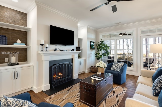 living room featuring ornamental molding, dark wood-type flooring, and ceiling fan