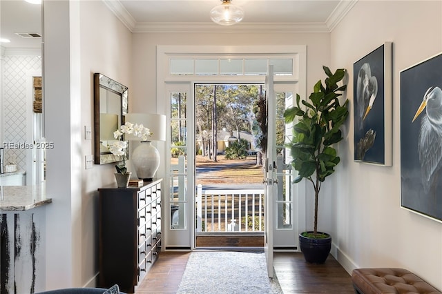 foyer entrance featuring ornamental molding and dark hardwood / wood-style floors