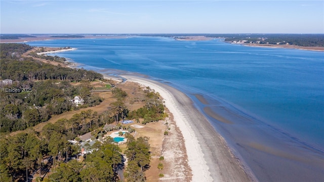 bird's eye view with a water view and a beach view