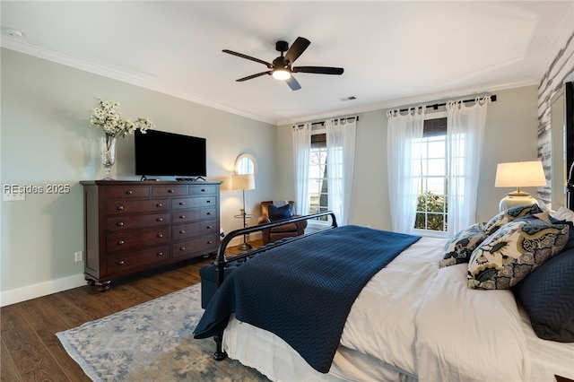 bedroom with ornamental molding, dark hardwood / wood-style floors, and ceiling fan