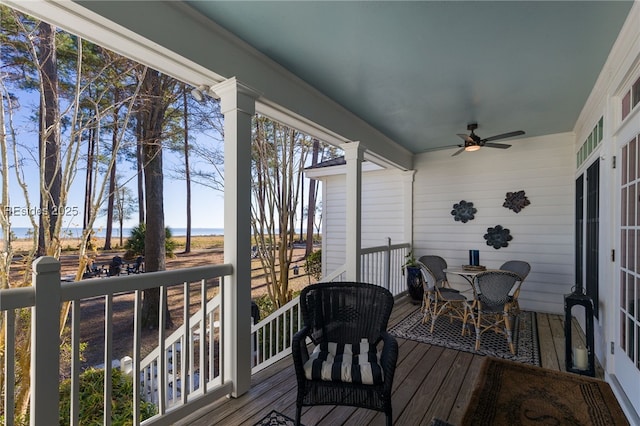 wooden terrace featuring ceiling fan