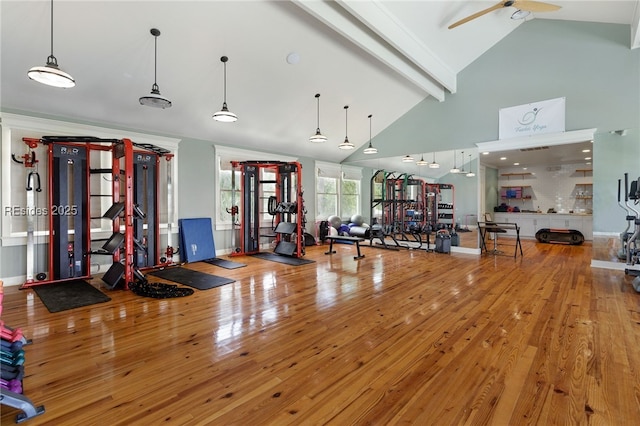 gym featuring hardwood / wood-style flooring, ceiling fan, and lofted ceiling