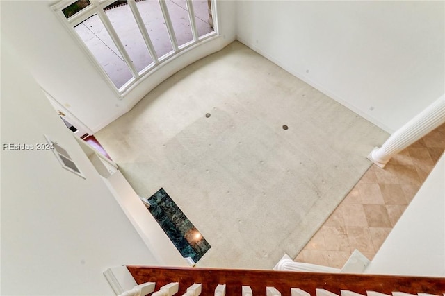 stairs with lofted ceiling and tile patterned floors