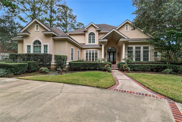 view of front of house featuring a front lawn and french doors