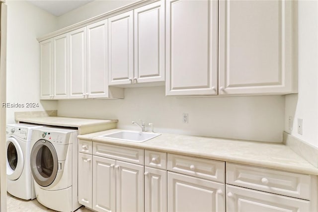 laundry room with cabinets, sink, and washing machine and dryer