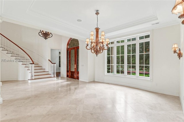 unfurnished dining area with an inviting chandelier, a tray ceiling, and ornamental molding