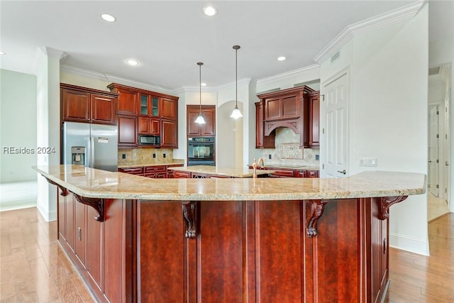 kitchen with a breakfast bar area, hanging light fixtures, decorative backsplash, and black appliances