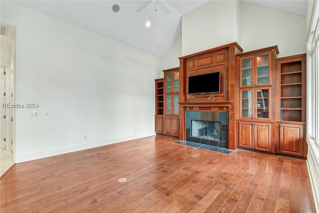 unfurnished living room featuring high vaulted ceiling, light hardwood / wood-style floors, and ceiling fan