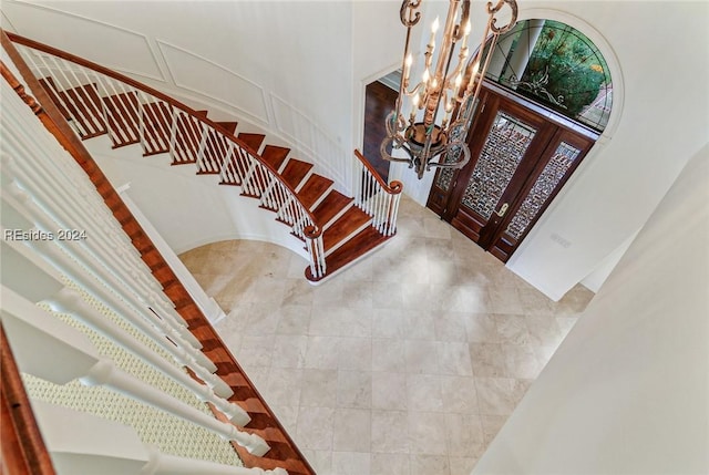 entrance foyer featuring french doors and a notable chandelier