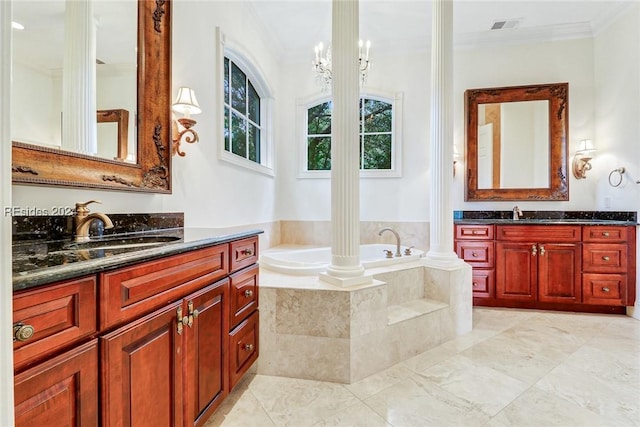 bathroom with ornate columns, ornamental molding, vanity, tiled tub, and an inviting chandelier