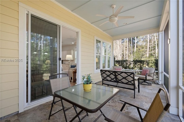 sunroom featuring ceiling fan