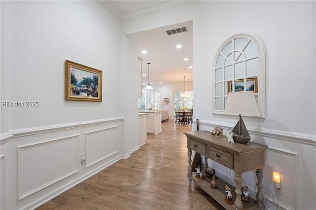 hall featuring crown molding and hardwood / wood-style floors