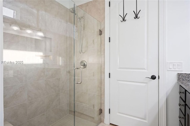 bathroom featuring vanity and a shower with shower door