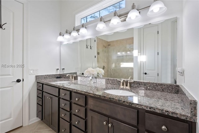 bathroom featuring vanity, tile patterned flooring, and a shower with door