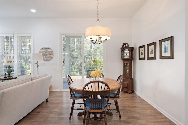 dining room featuring an inviting chandelier, plenty of natural light, and hardwood / wood-style floors