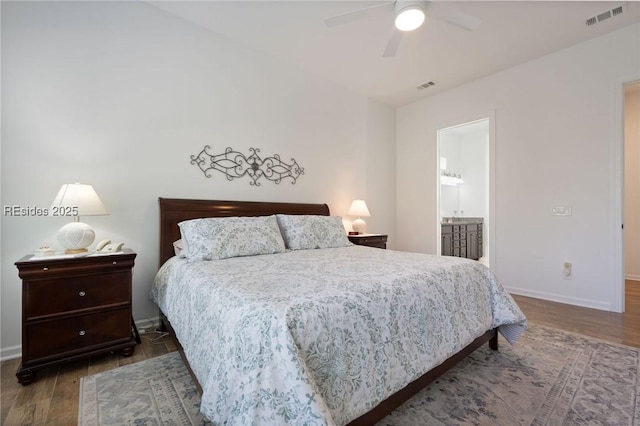 bedroom with ensuite bath, dark hardwood / wood-style floors, and ceiling fan