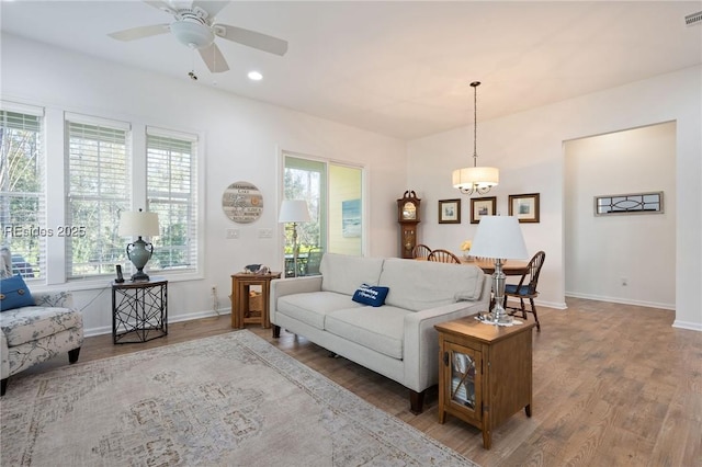 living room featuring hardwood / wood-style floors and ceiling fan