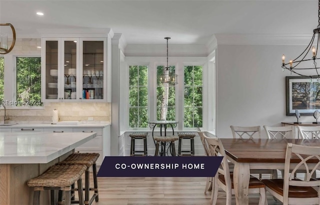 dining space featuring an inviting chandelier, sink, and a wealth of natural light