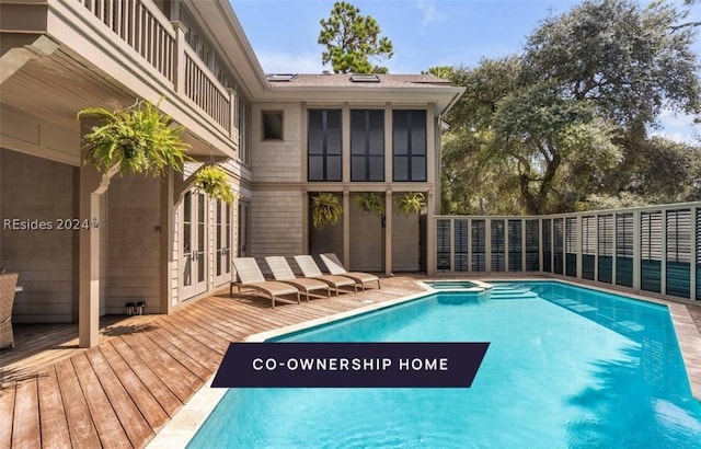 view of pool with a wooden deck, an in ground hot tub, and french doors